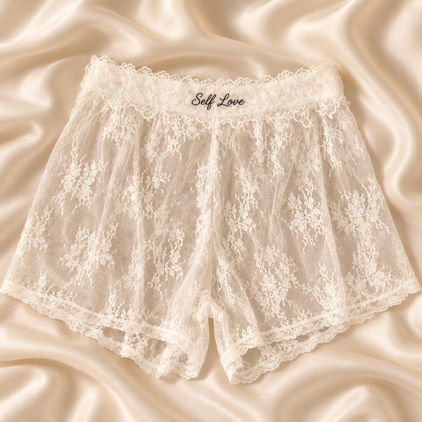 White lace shorts shown with a black cursive Self Love monogram example